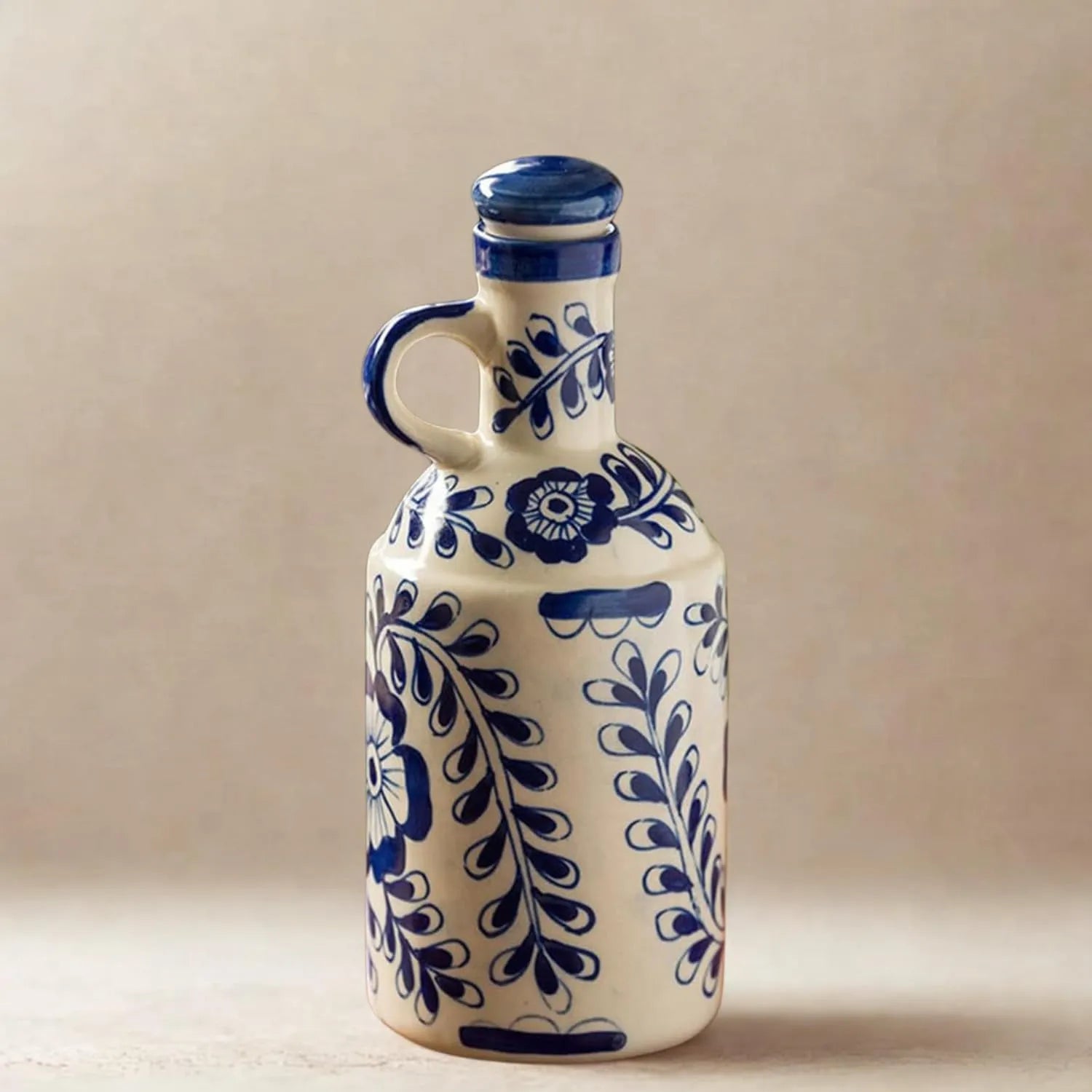 Ceramic bottle with blue floral patterns on a beige background