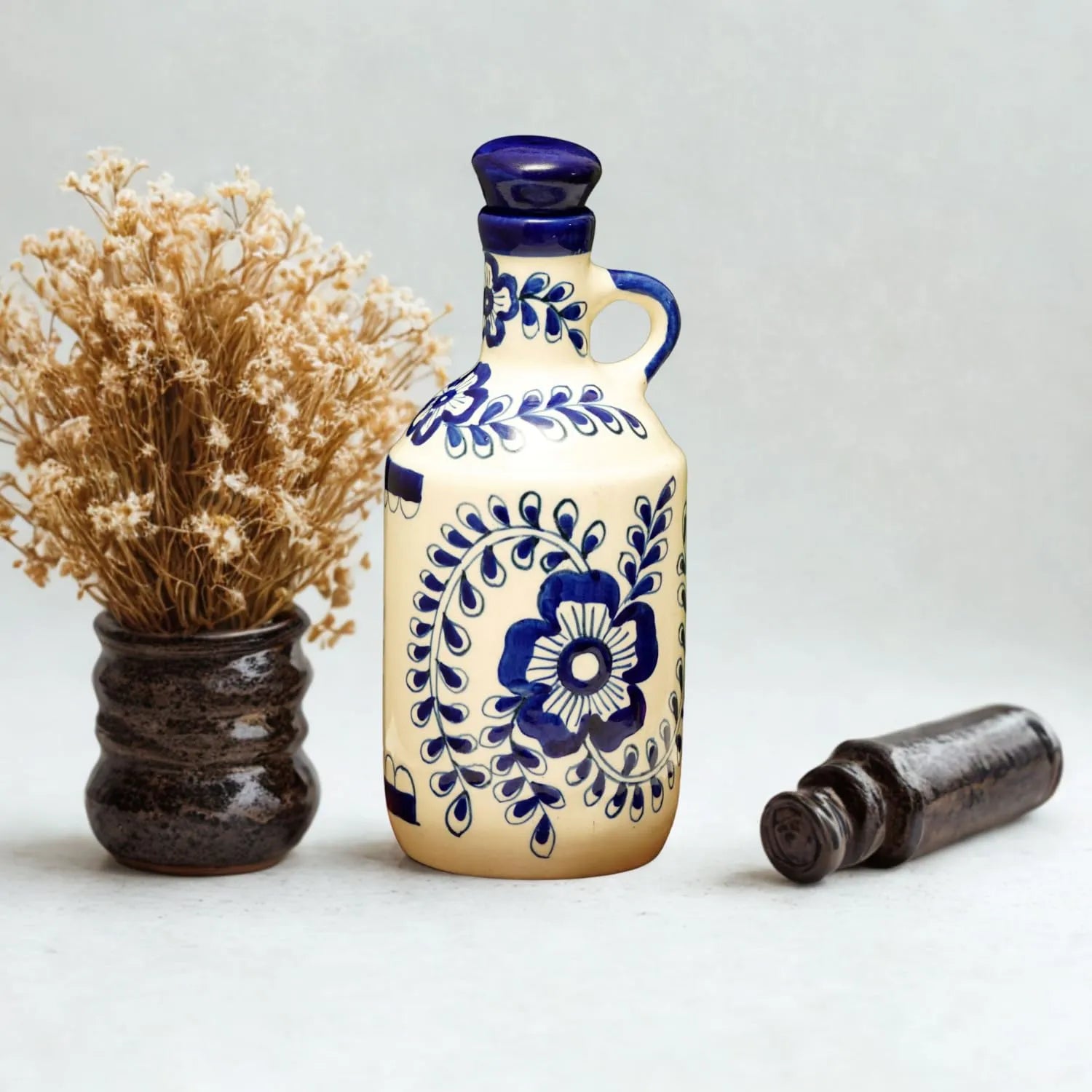 Decorative ceramic bottle with blue floral patterns on a white background