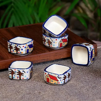 Set of small ceramic bowls with colorful patterns on a wooden tray.