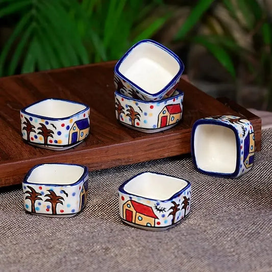 Set of small ceramic bowls with colorful patterns on a wooden tray.